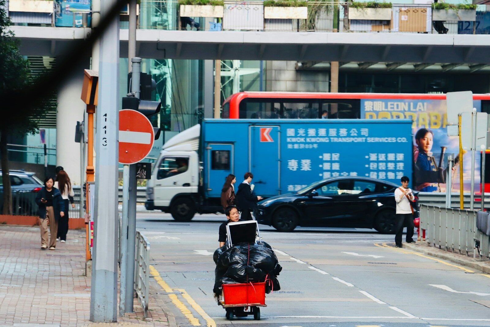 People and vehicles on a busy city street.