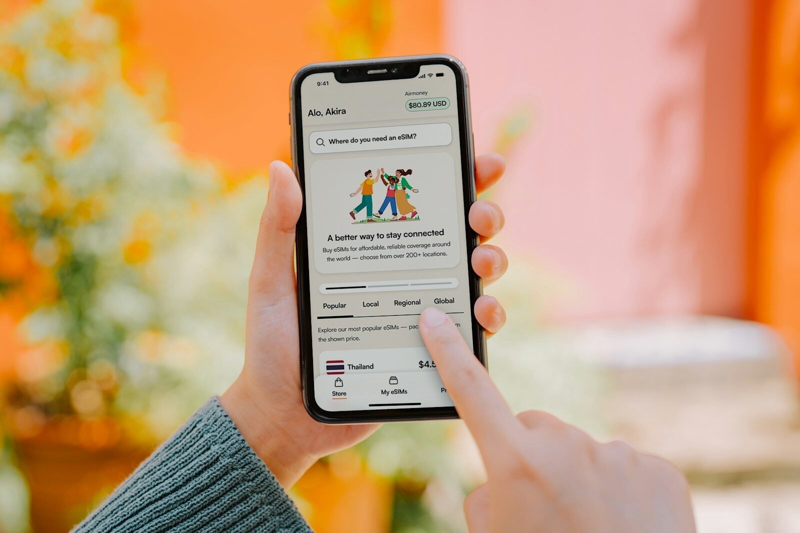 Person using a smartphone with colorful background.