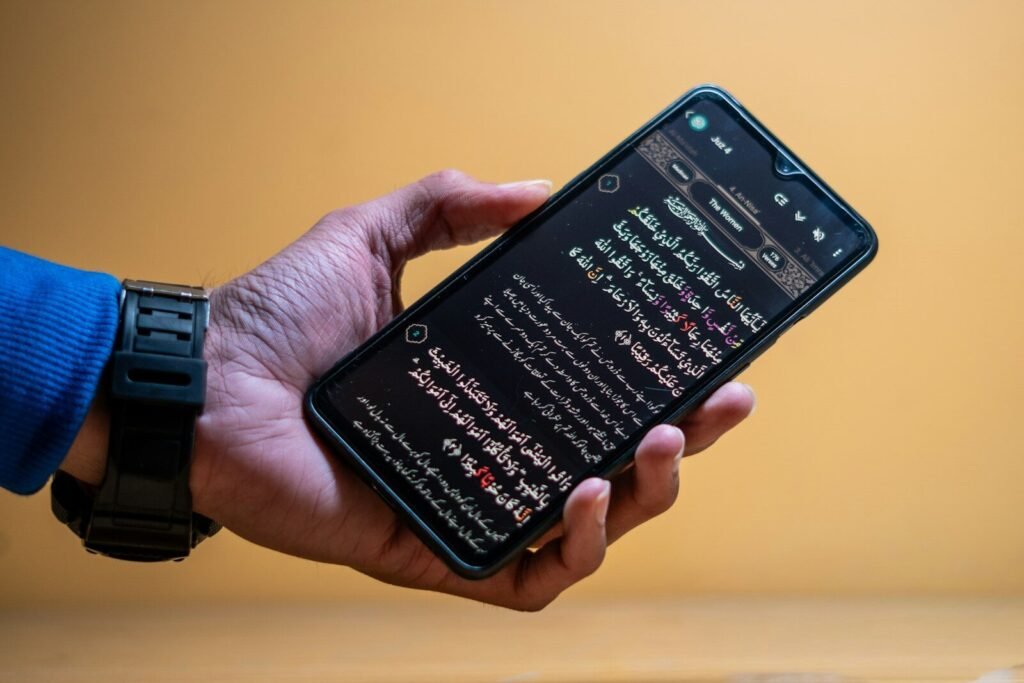 Hand holding smartphone displaying text on screen