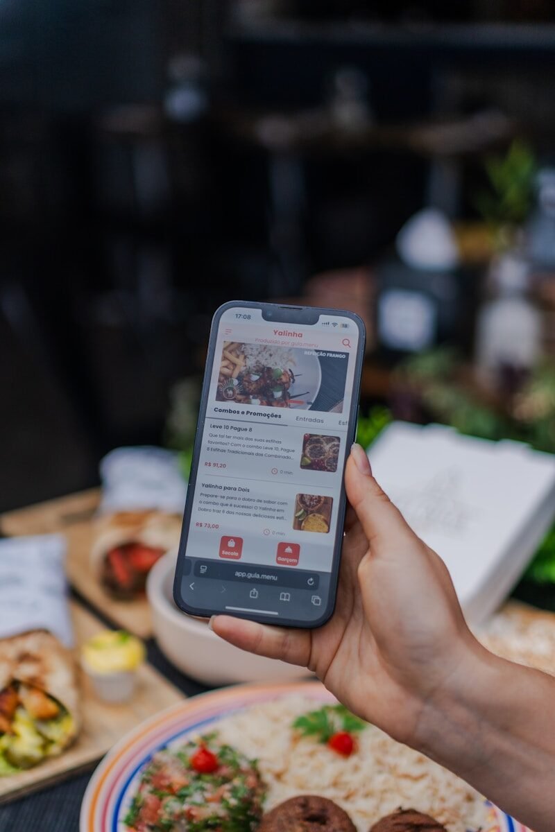 Hand holding smartphone displaying food ordering app.